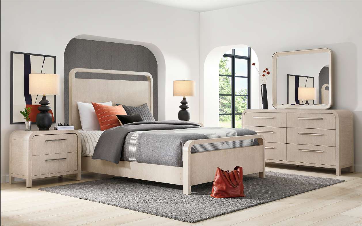 Bedroom furniture set with a bed, nightstands, dresser, and mirror.

