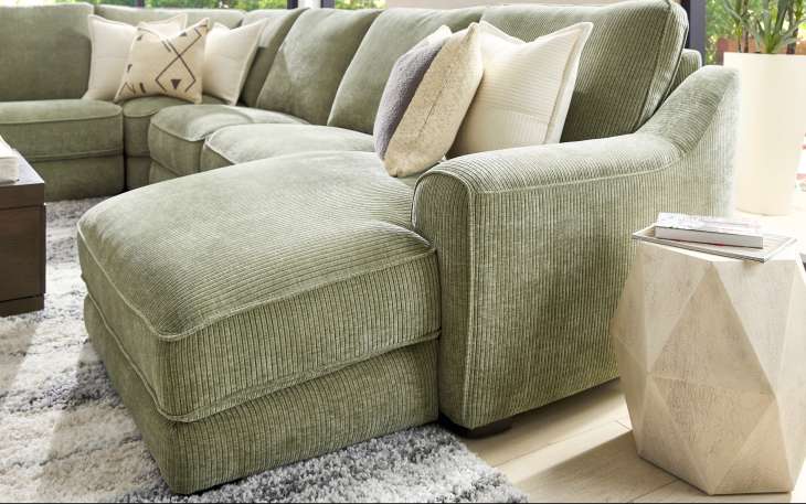 Gray sectional sofa with throw pillows and a coffee table.
