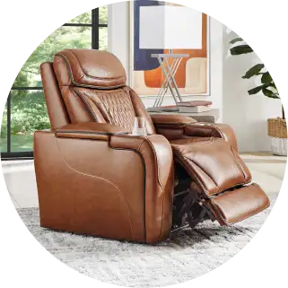 Brown leather recliner chair with cup holder and footrest extended.
