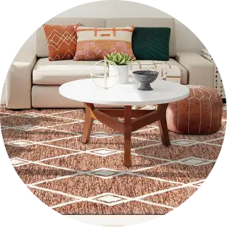 Living room with a white coffee table, sofa, and patterned rug.
