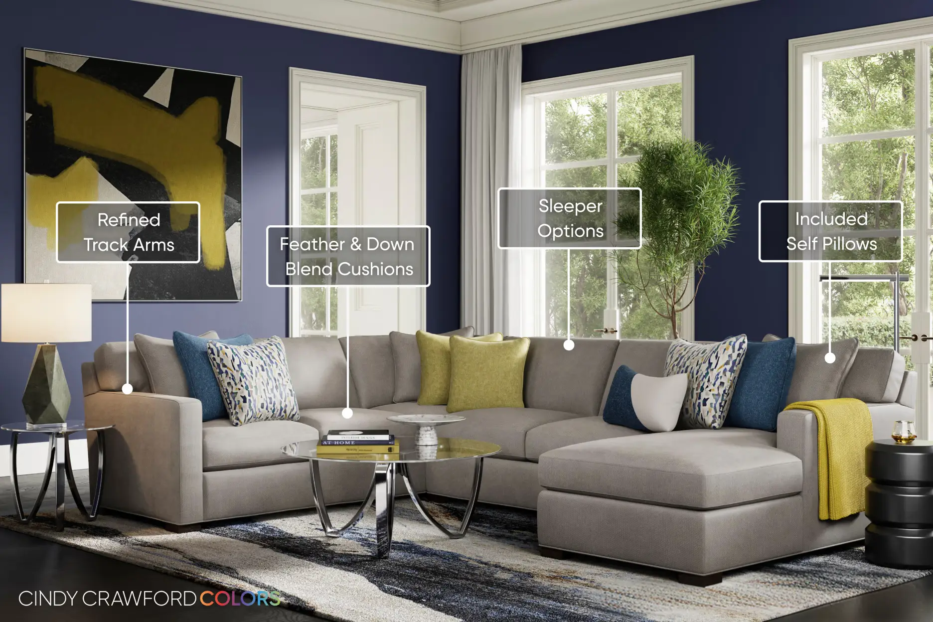Cindy Crawford Colors: A light gray sectional sofa with track arms, feather-down cushions, and accent pillows in a living room.