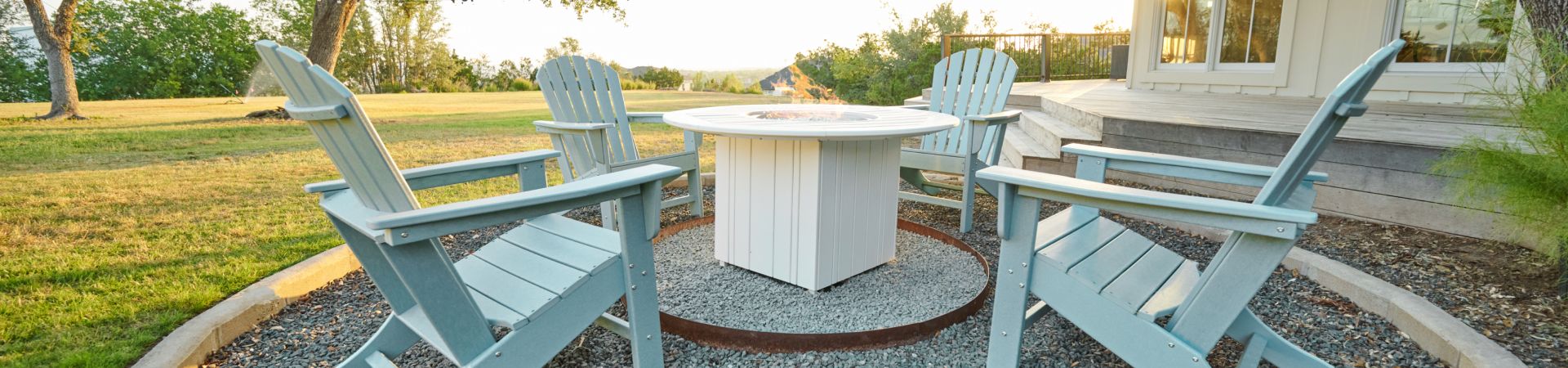 blue chairs around a fire pit