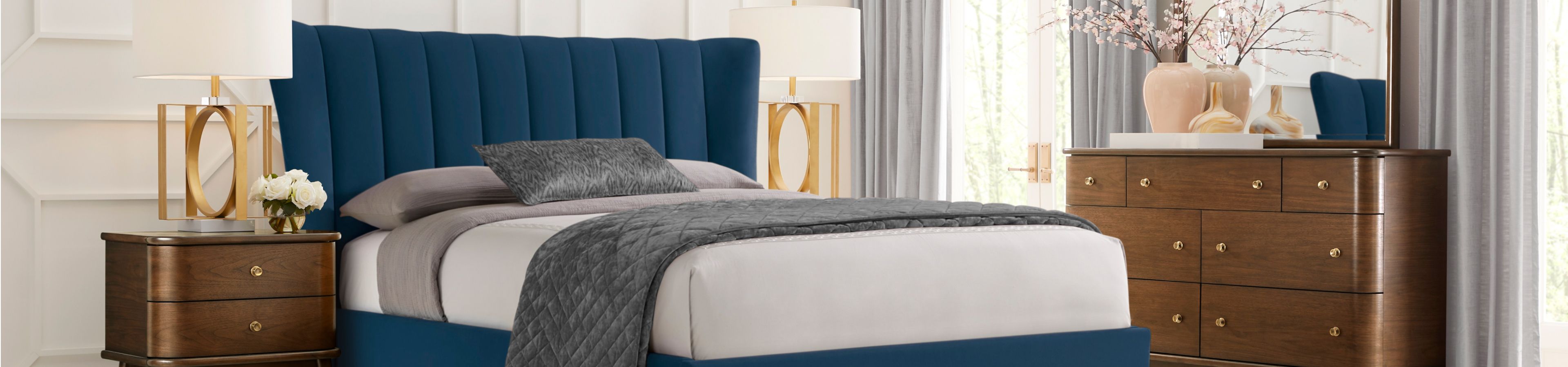 Bedroom set with a blue bed, nightstands, and a dresser.
