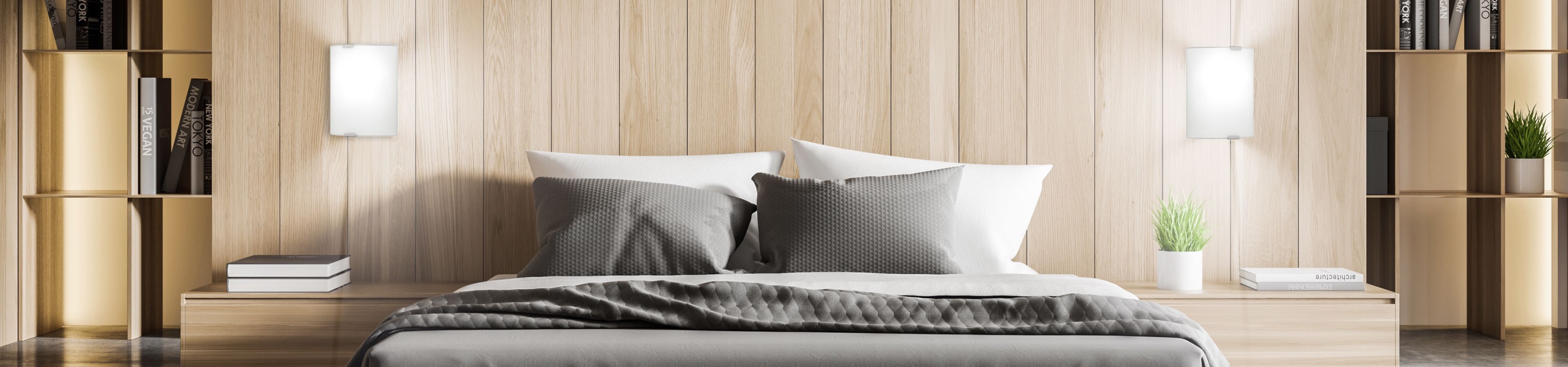 Bedroom with wooden headboard, bed, pillows, and bookshelves.
