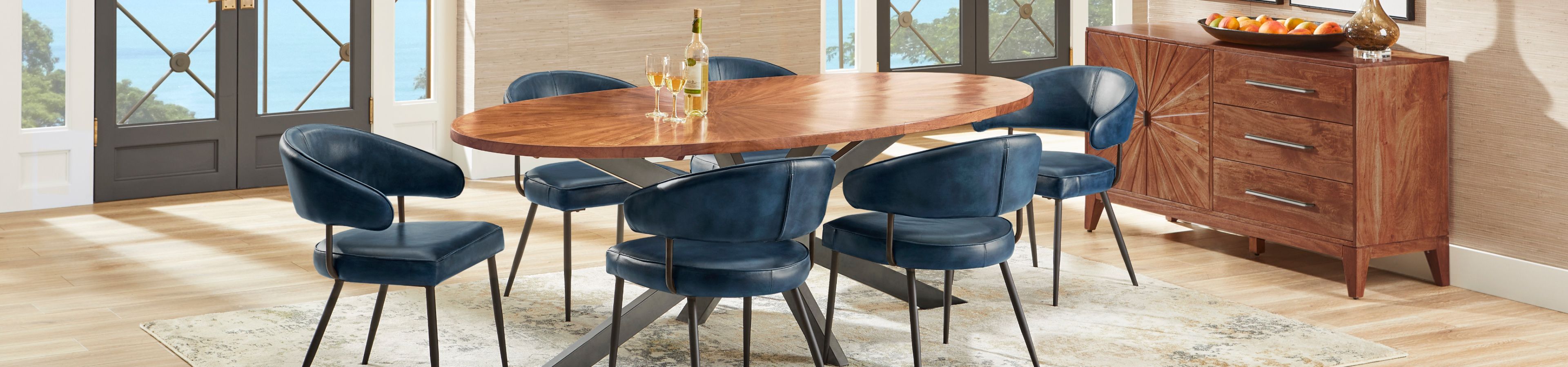 A dining room set with a wooden table, blue chairs, and a wooden cabinet.
