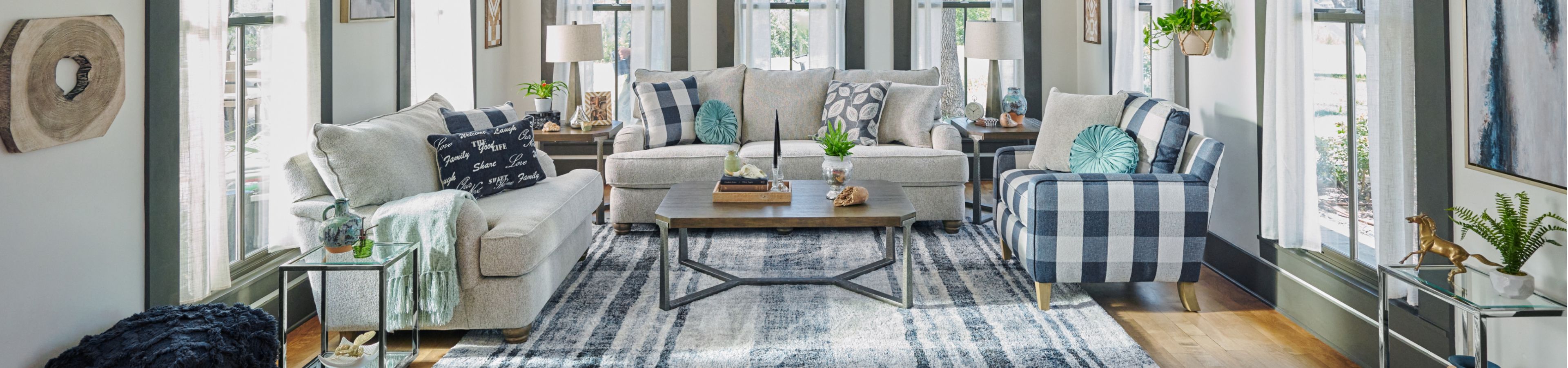 Living room with a light gray sofa, a blue and white checkered armchair, and a wooden coffee table.
