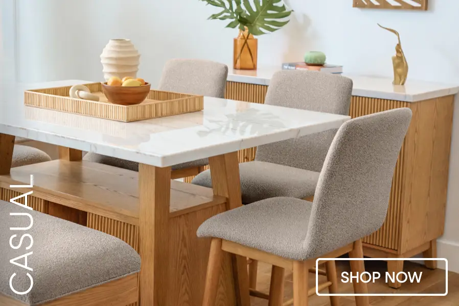 CASUAL SHOP NOW. A dining room set featuring a marble-topped table, upholstered chairs, and a wooden bench.