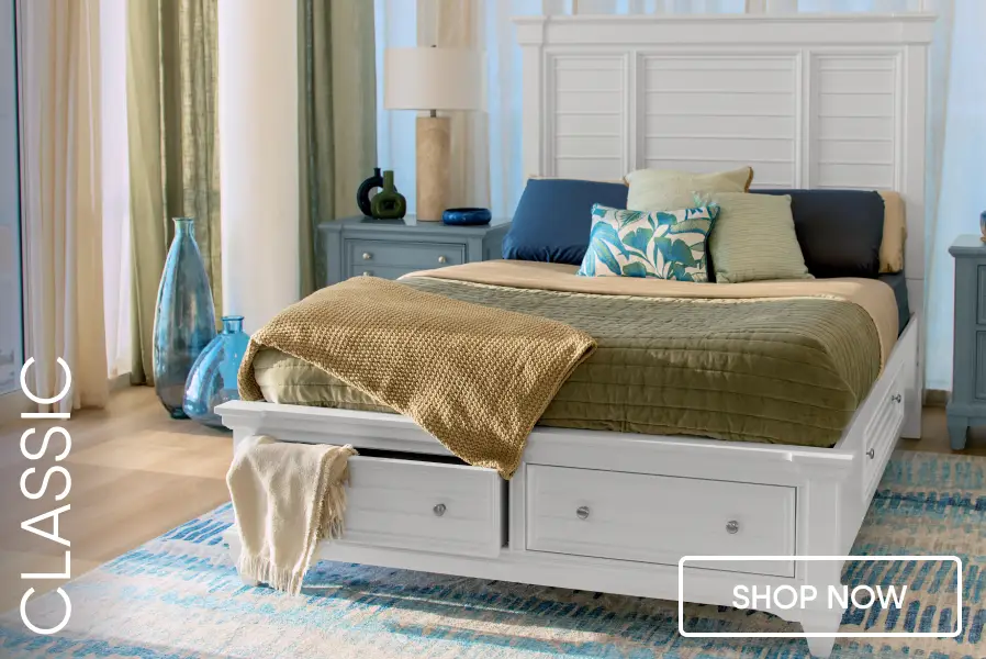 CLASSIC SHOP NOW: A white wooden storage bed with drawers, styled with a green quilt and blue accents in a bedroom.