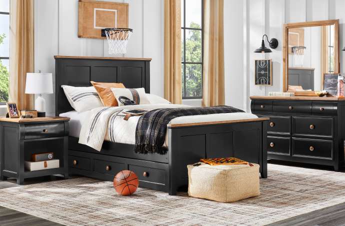 A bedroom set with a black bed, dresser, and nightstand. A basketball hoop is mounted on the wall.
