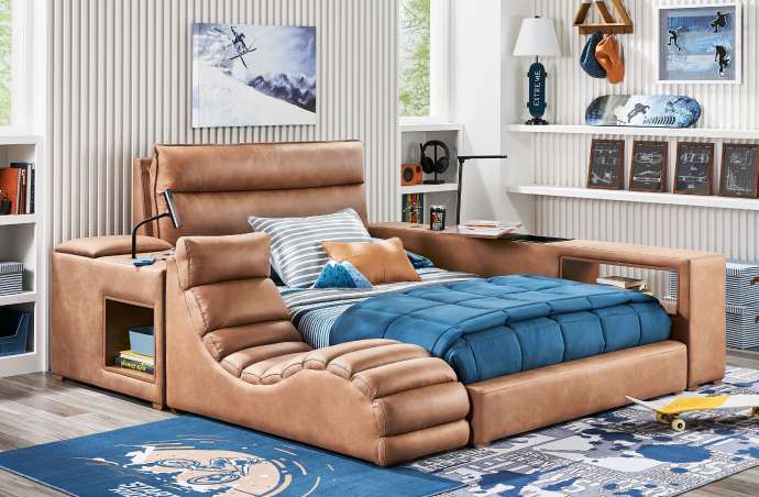 A brown leather bed with built-in side tables, a reading lamp, and a blue comforter.