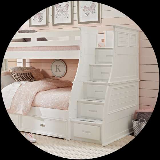 White bunk bed with stairs and storage drawers.
