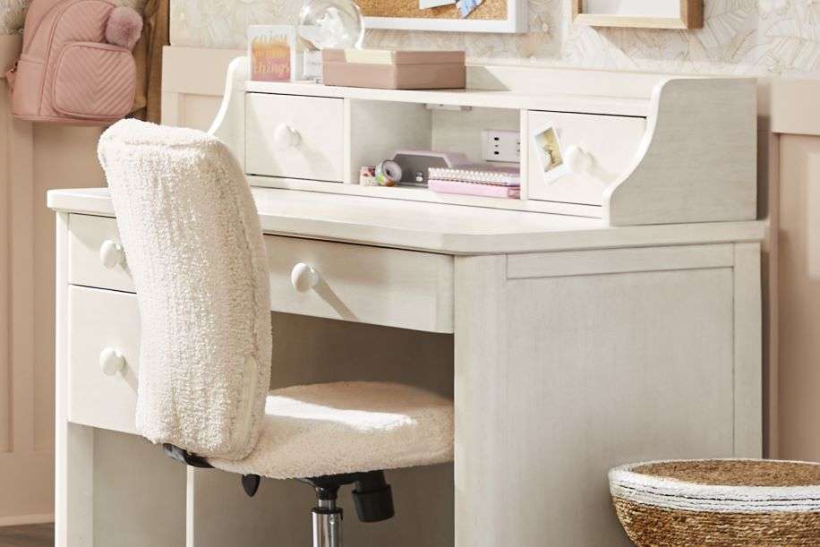 White desk with a fluffy chair.
