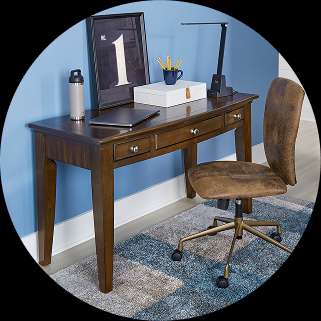 Wooden desk with drawers, a chair, and accessories.
