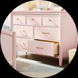 Pink dresser with gold hardware.
