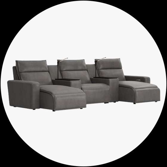 Gray leather home theater seating with chaise lounges and reading lights.
