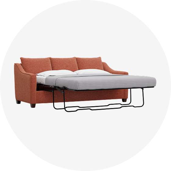 Orange sofa bed with a pull-out mattress.
