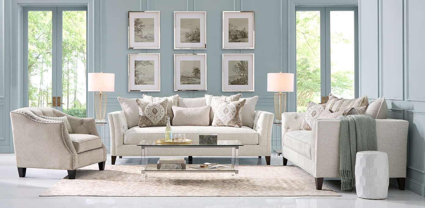Living room with two sofas, an armchair, and a glass coffee table.
