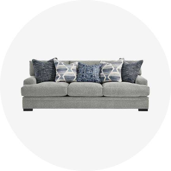 Gray sofa with blue patterned pillows.
