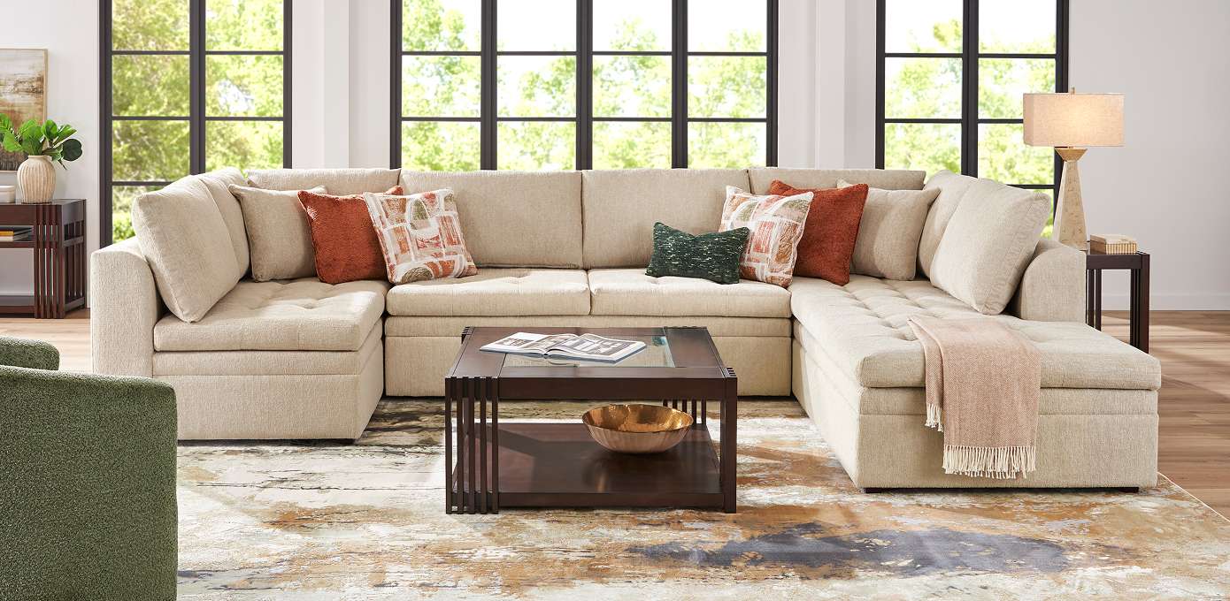 Beige sectional sofa with throw pillows and a coffee table.
