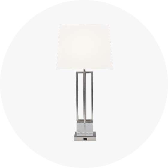 Table lamp with a white lampshade and a silver base.

