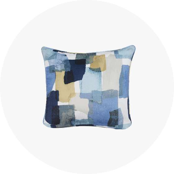 Pillow with abstract blue and tan pattern.
