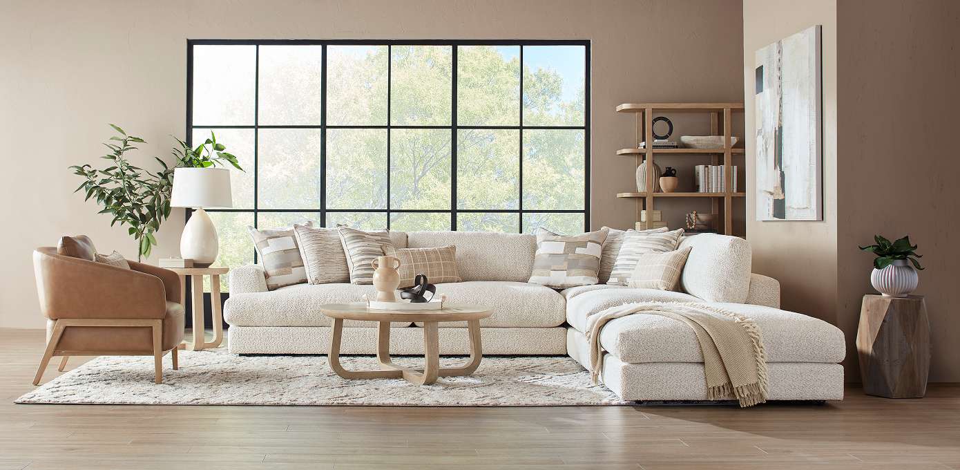 A modern living room with a sectional sofa, armchair, and coffee table.
