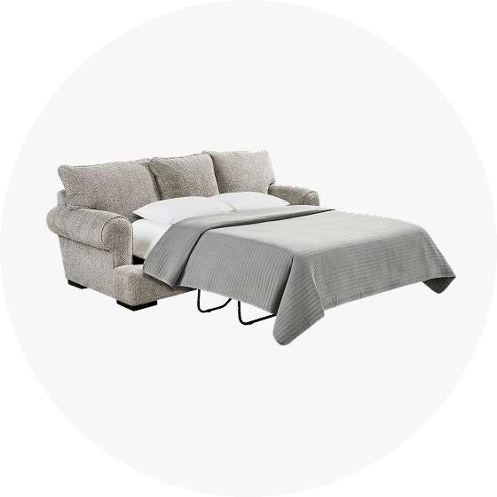 Gray sofa bed with a gray blanket.
