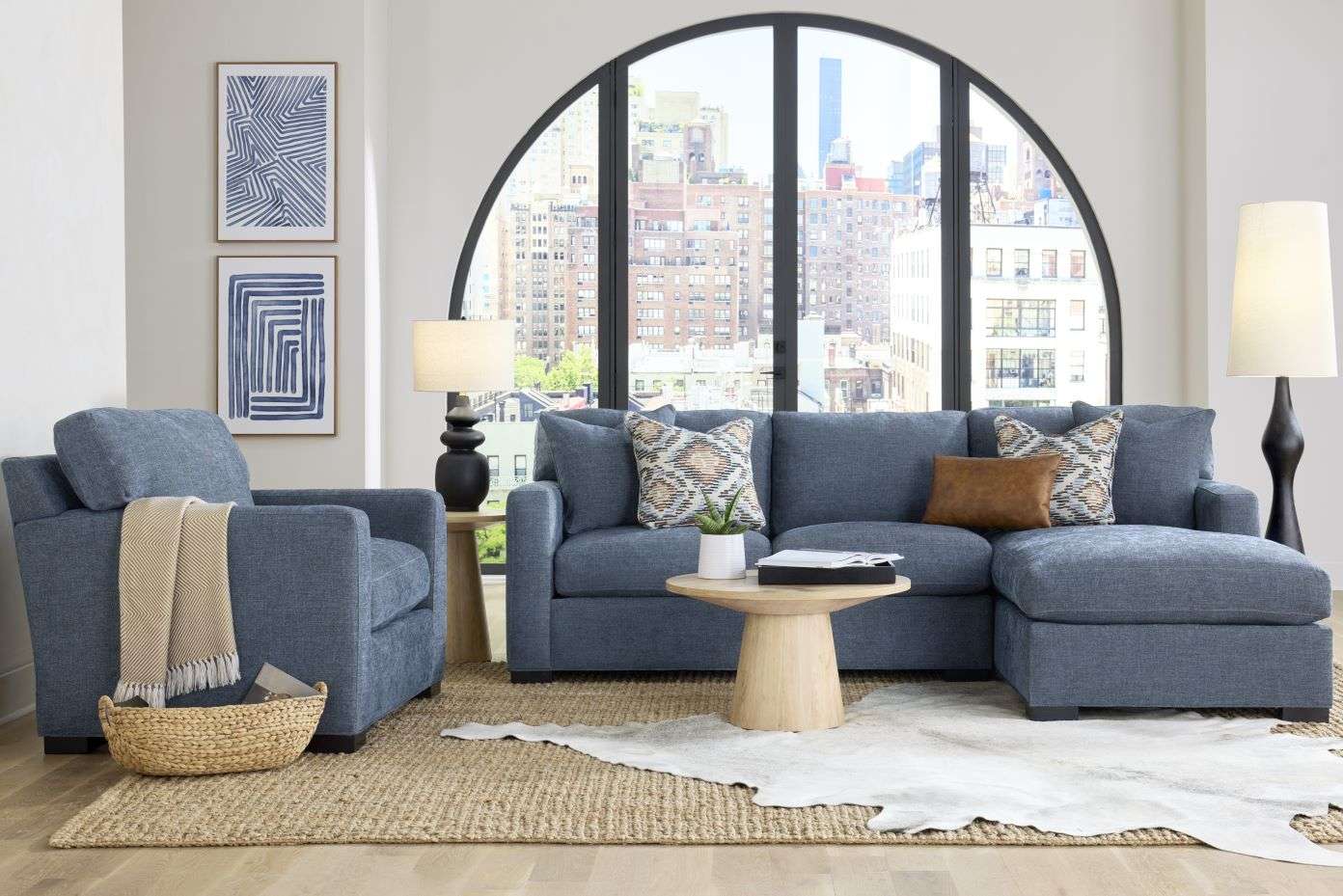 Blue sectional sofa with accent pillows in a modern living room.
