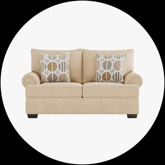 Beige loveseat with two patterned pillows.
