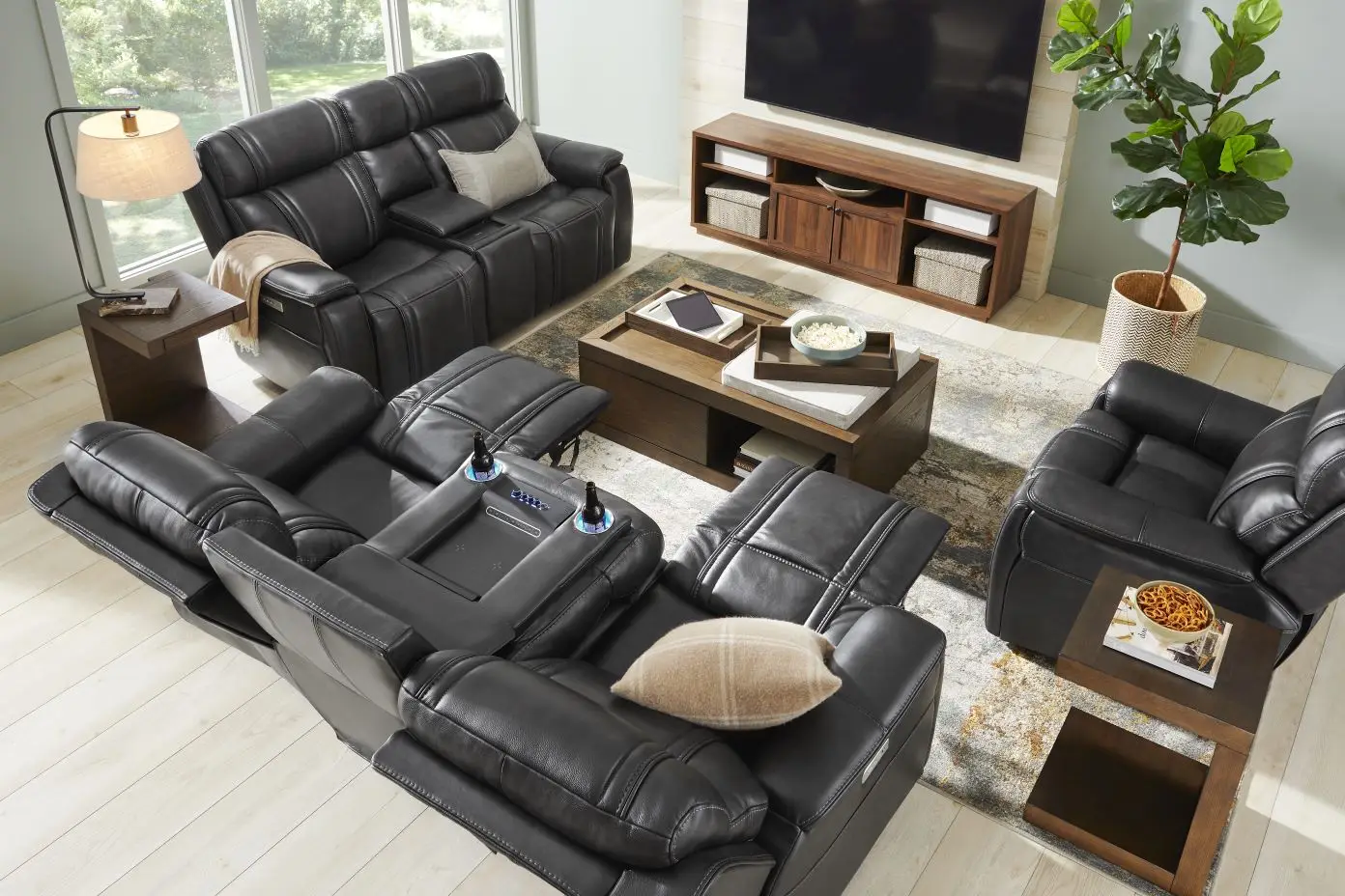Black leather reclining sofa and chairs in a living room.
