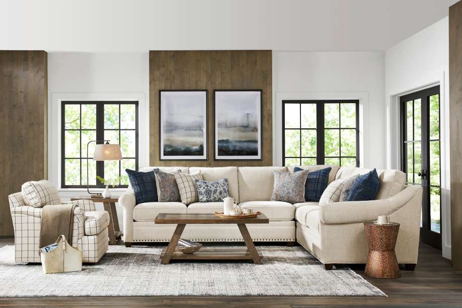 A living room with a sectional sofa, armchair, and coffee table.
