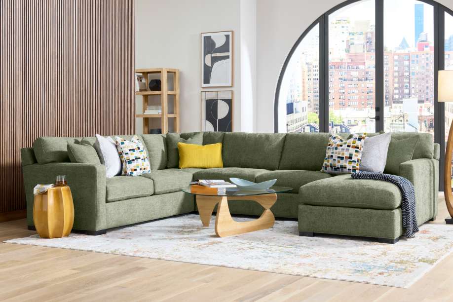Green sectional sofa in a modern living room.
