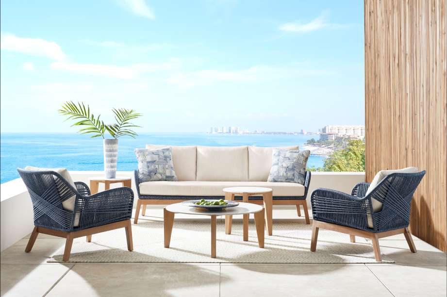 Outdoor furniture set with a sofa, two armchairs, and two side tables.
