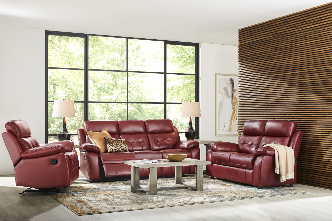 Red leather living room furniture set with a sofa, recliner, and loveseat.
