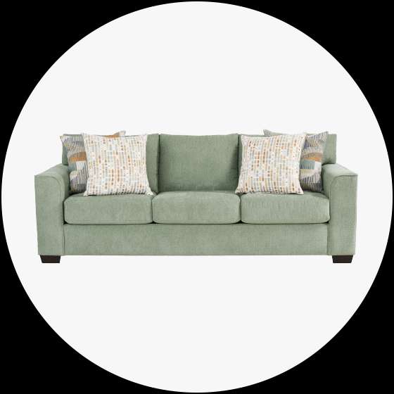 Green sofa with patterned throw pillows.

