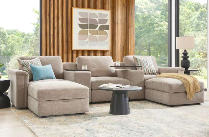 Beige sectional sofa with side tables and throw pillows.
