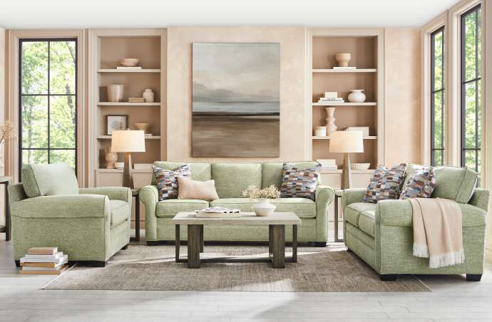Living room with green sofa, two armchairs, and a coffee table.
