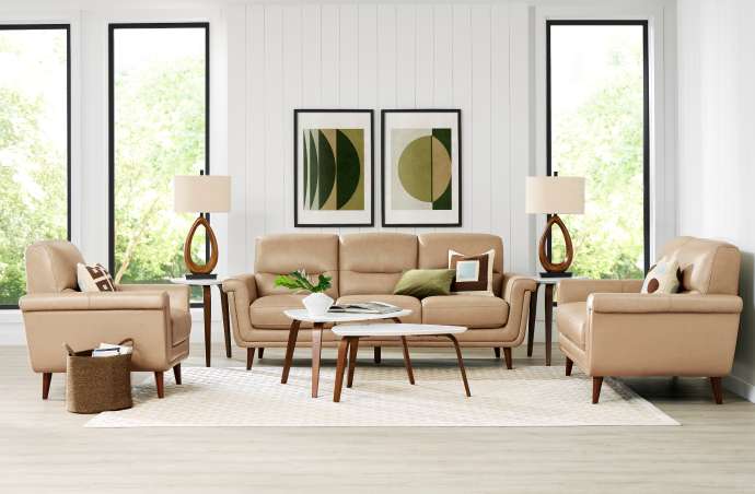 Living room with tan leather furniture, two armchairs, a sofa, and a coffee table.
