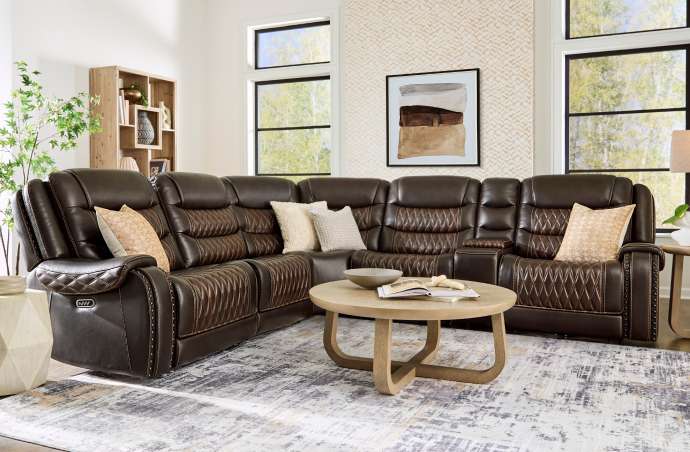 Brown leather sectional sofa with diamond stitching.
