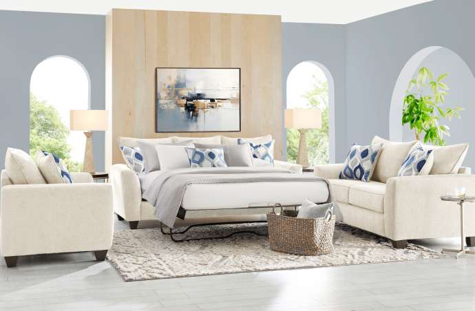 Living room furniture set with a sofa bed, two armchairs, and a rug.

