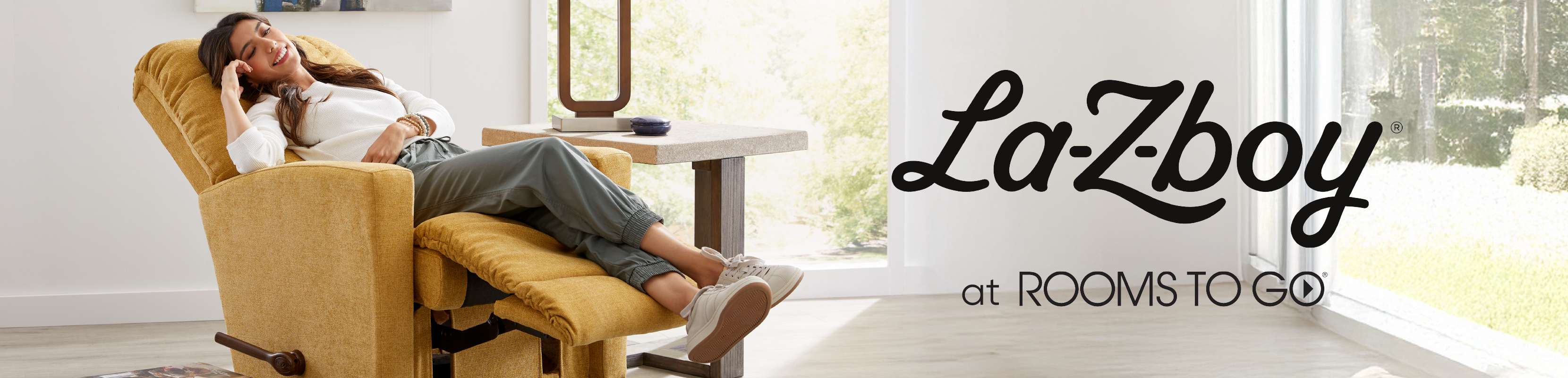 La-Z-boy at Rooms To Go. A woman relaxes in a yellow recliner.