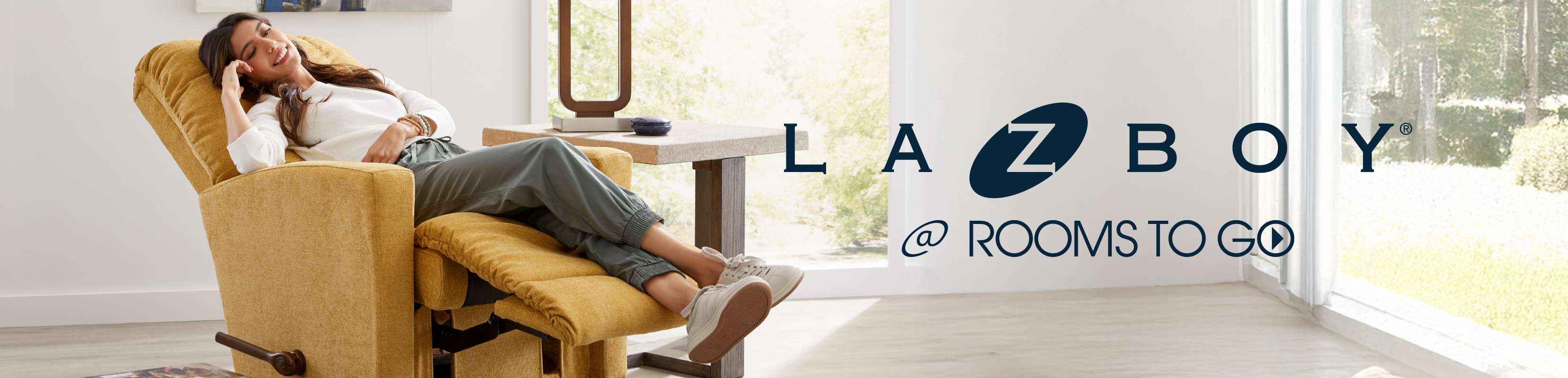 LA-Z-BOY @ ROOMS TO GO. A woman relaxes in a yellow recliner.