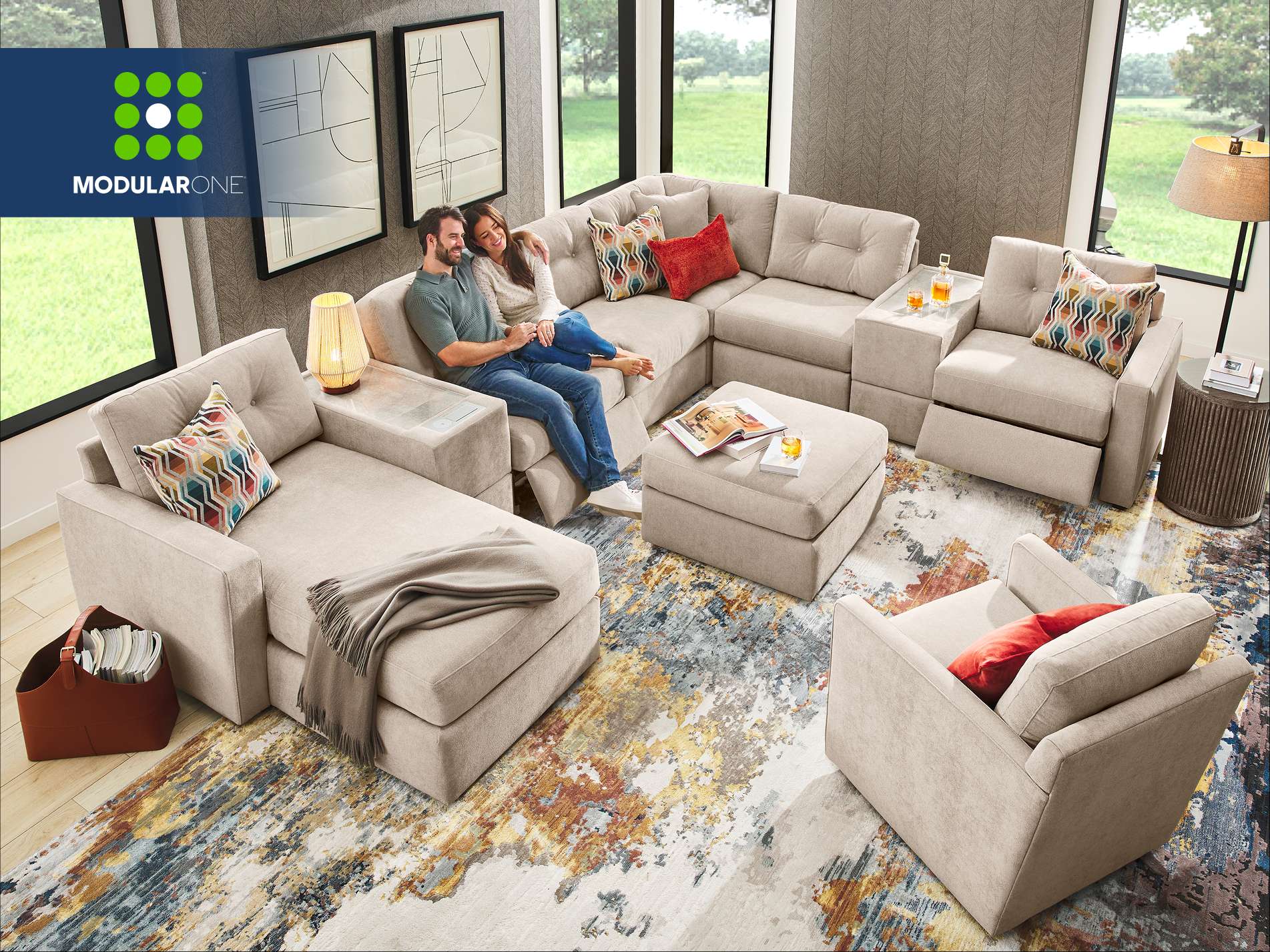 Modular One. A beige sectional sofa with a couple sitting on it.
