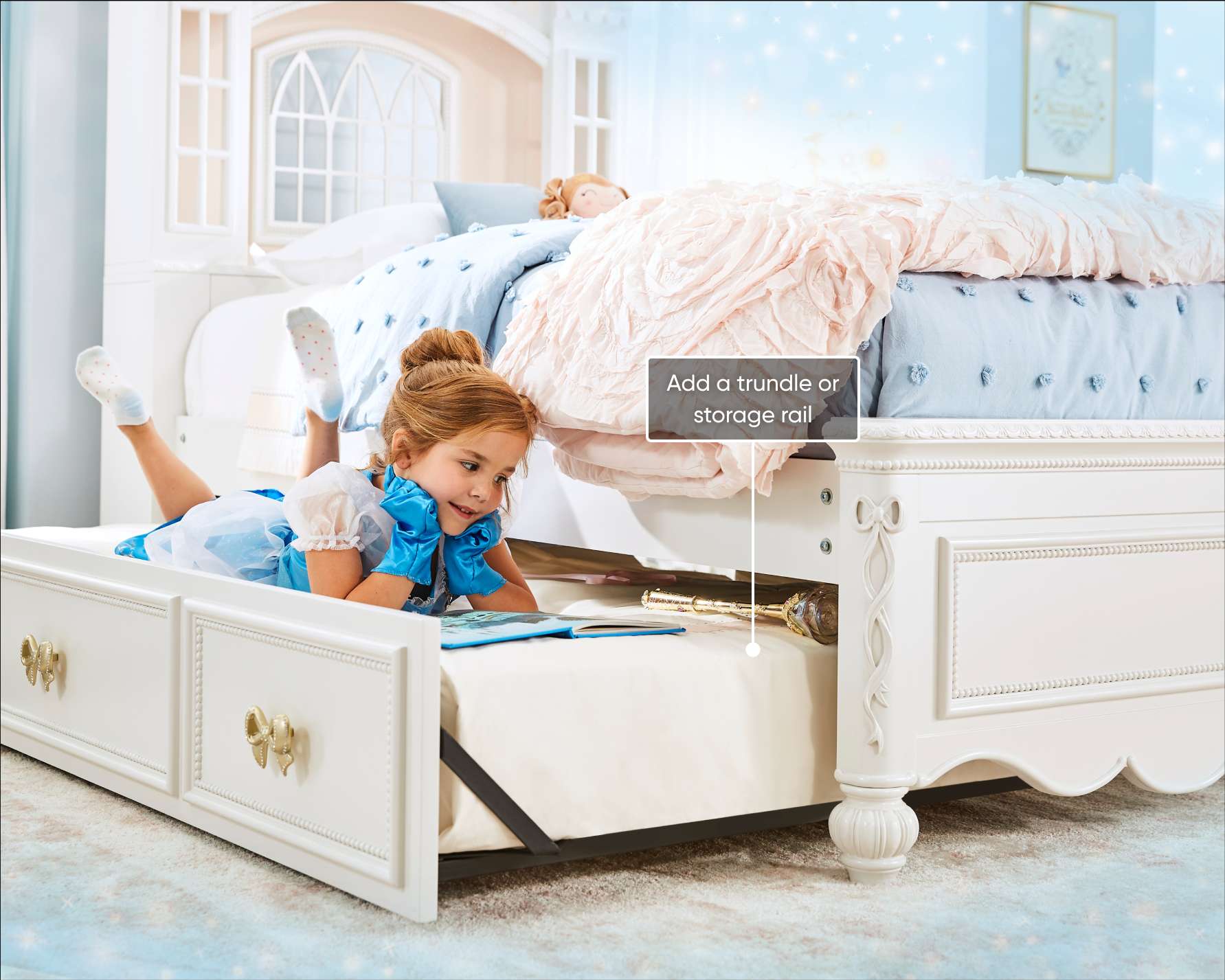 Add a trundle or storage rail. A girl in a Cinderella costume is reading on a bed.
