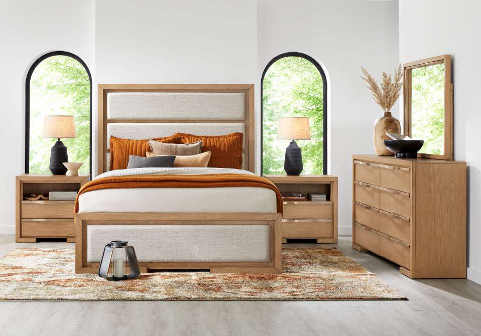 Bedroom furniture set with a bed, nightstands, and a dresser.
