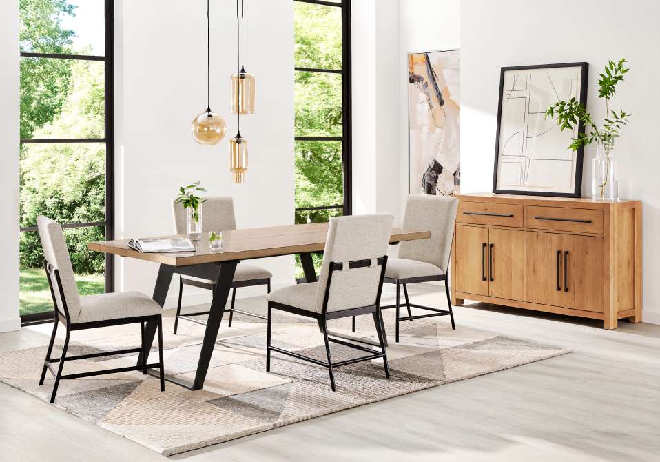 Dining room set with a wooden table, chairs, and a rug.