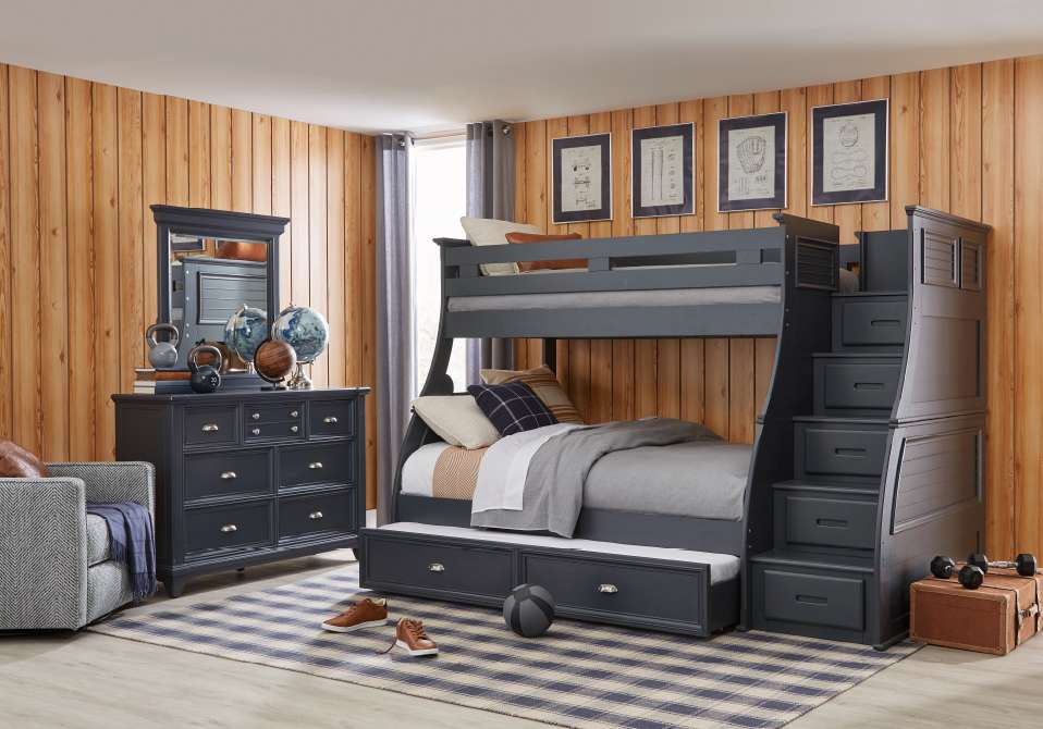 A dark gray bunk bed with stairs and a dresser in a bedroom.
