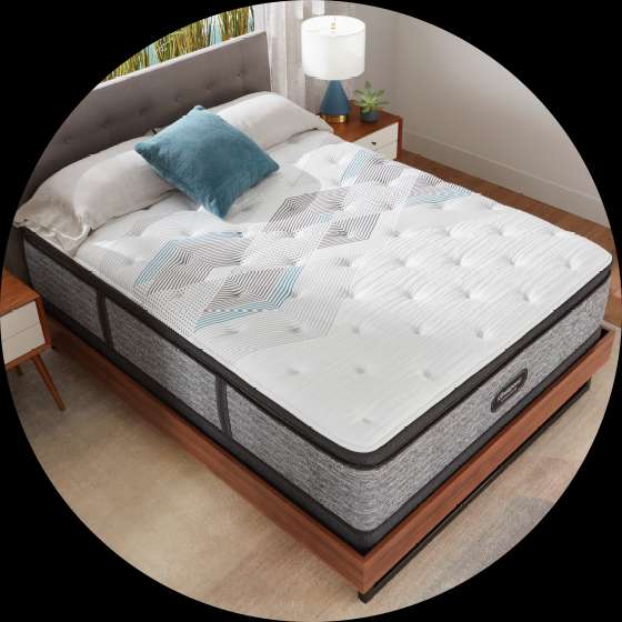 Mattress on a wooden bed frame.
