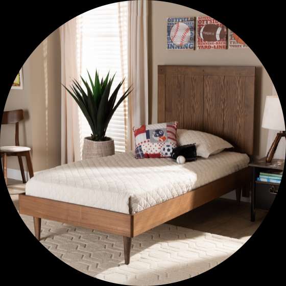A wooden bed with a headboard, a pillow, and a baseball glove.

