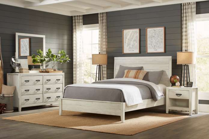 Bedroom furniture set with a bed, dresser, and nightstand.
